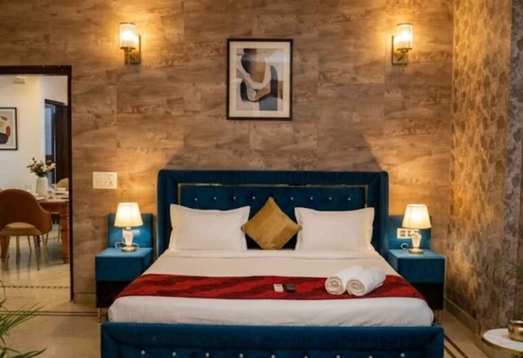 Premium fully furnished bedroom featuring a modern blue velvet bed at Divine India Service Apartments, offering luxury stays across Saket, Delhi, and Noida, NCR.